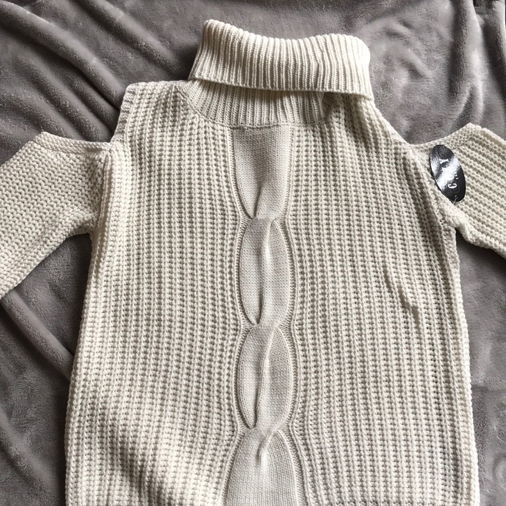 Turtle neck sweater with should cut outs.